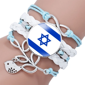 Detail of multi-layer bracelet featuring Israel flag pendant and infinity charm with bird