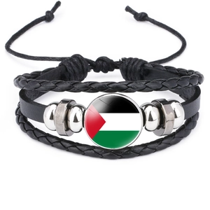 Detailed macro view of black leather bracelet with Palestine flag glass dome and metal beads