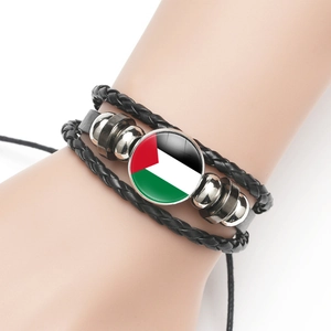 Detailed close-up of woven leather bracelet featuring Palestine flag glass dome charm
