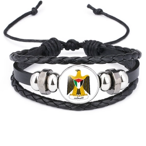 Detail of multi-layer leather bracelet with Palestine emblem under round glass dome