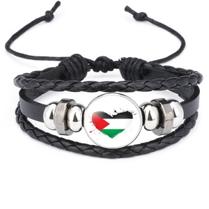 Detailed view of Palestine flag heart glass gem on a multilayer black leather bracelet