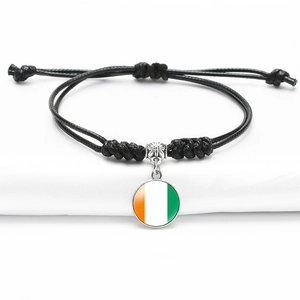 Handmade woven black rope bracelet featuring Central African Republic flag pendant