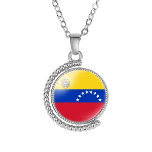 Detail view of rotating moon necklace with Venezuela flag gem and silver chain