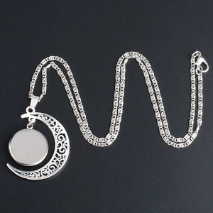 Silver crescent moon necklace with European flag glass gem pendant on a textured black base