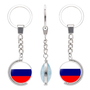Macro detail of rotating silver keychain featuring the Russian flag design and polished finish
