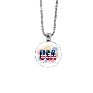 Detailed close-up of round glass pendant with USA flag letters and fireworks pattern