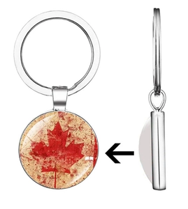 Macro view of silver Canadian flag maple leaf keychain with domed glass pendant