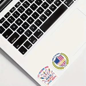 Detail of 250th anniversary stickers on a laptop featuring US flags and 1776-2026 text