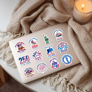 Detailed stickers showing USA 250th anniversary symbols on a laptop with soft lighting
