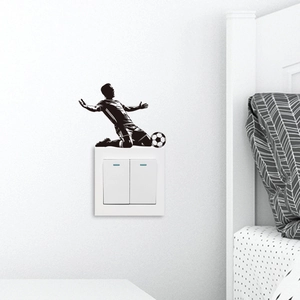 Detail showing a black football player silhouette decal applied on a white wall switch