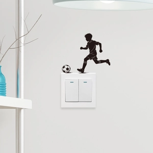 Soccer boy silhouette wall decal above light switch for sports themed room decoration