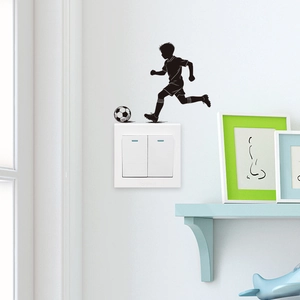 Black silhouette wall decal of a boy playing soccer for home light switch decoration