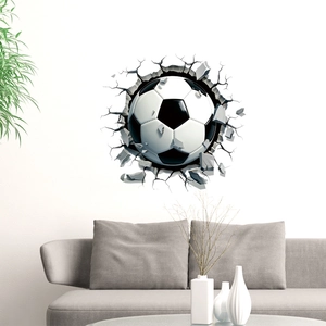 3D soccer ball wall decal with cracked wall effect above a modern grey sofa