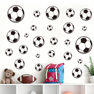 Classic black and white soccer wall decal set applied in a cozy nursery room setting