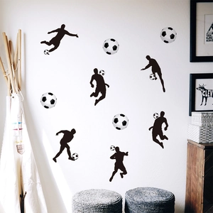 Detail of soccer player silhouettes and ball wall stickers in a cozy nursery room