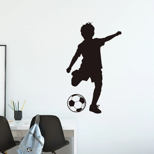 Waterproof vinyl silhouette wall decal of a boy kicking a soccer ball for room decor