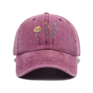 Burgundy washed cotton baseball cap with artistic floral print and cursive text embroidery