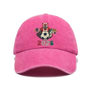 Close-up of peach pink washed cotton baseball cap with 2026 soccer tournament embroidery