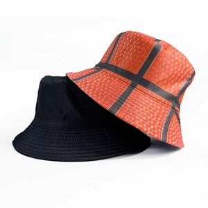 Reversible bucket hat with soccer patterns and textured basketball skin design in black and orange