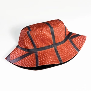 Detail showing orange basketball pattern bucket hat with textured rubber grip surface
