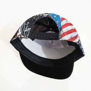 Detail view of American flag pattern and adjustable snapback closure on a baseball cap