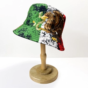 Reversible Mexico flag bucket hat with eagle emblem on a wooden stand in high detail