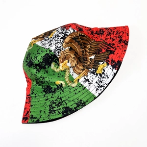 Detail of Mexico eagle crest on tri-color bucket hat with artistic ink splatter effects