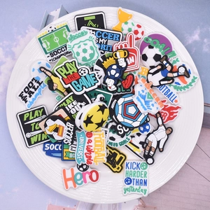 Soccer themed PVC shoe charms set featuring football patterns and sports motifs in a white bowl
