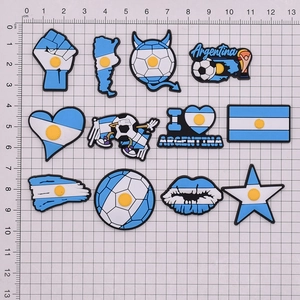 Detailed set of 12 Argentina soccer themed PVC shoe charms and pins on a scale mat