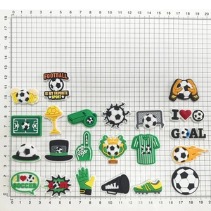 Macro detail of 20pcs football theme PVC shoe charms and sports accessories set