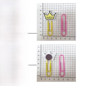 Detail of yellow crown paper clip with QUEEN text showing size dimensions and scale