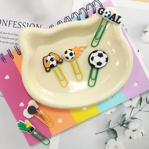 Detail of soccer themed paper clips featuring goal and goalkeeper glove charms