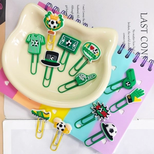 Close-up of creative soccer-themed paper clips and bookmarks on a cat tray and notebook