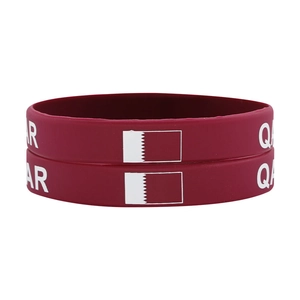 Detail of two burgundy Qatar national flag silicone wristbands for sports events