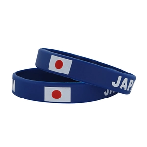 Close-up of durable navy blue silicone sports wristbands featuring the Japan flag and text