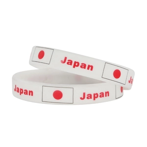 Detail showing two white silicone wristbands with Japan flag and red text print