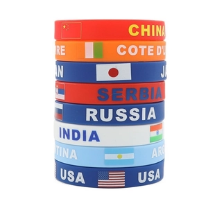 Stack of 2026 World Cup silicone wristbands featuring national flags and country names