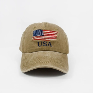 Detailed close-up of embroidered American flag and USA logo on washed khaki baseball cap