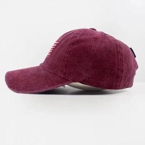 Detail of vintage washed cotton baseball cap with embroidered stripes in burgundy