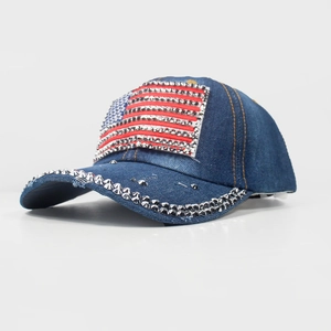 Detail of denim baseball cap featuring American flag rhinestones and silver metal studs
