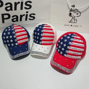 Close-up of assorted American flag baseball caps decorated with sparkling rhinestones