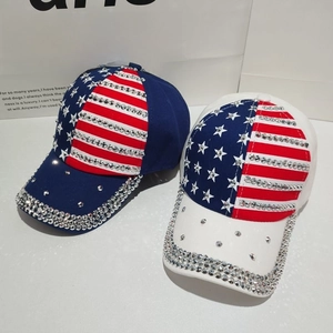 Detailed close-up of blue and white US flag baseball caps with hand-set sparkling rhinestones