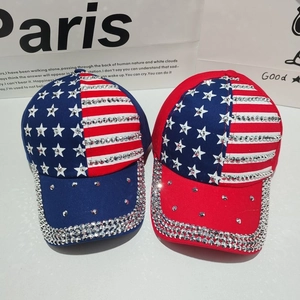 Detailed view of two baseball caps with American flag pattern and hand-set silver rhinestones