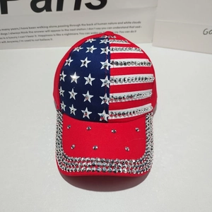 Detailed view of US flag baseball cap featuring red white stripes and shiny rhinestones