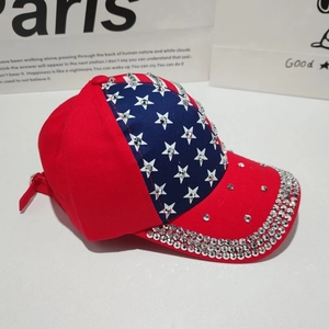 Detailed view of American flag baseball cap with hand-set rhinestones and star pattern