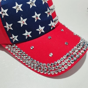 Detailed view of glittering silver rhinestones on a US flag pattern baseball cap