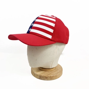 Detail view of red baseball cap with embroidered American flag stars and stripes on the front