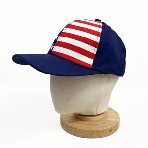 Detailed side view of navy baseball cap featuring stars and stripes flag design