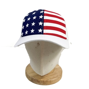 Detail of USA flag pattern with white stars and red stripes on a cotton baseball cap
