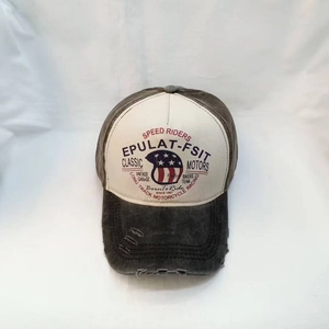 Close-up of vintage washed baseball cap featuring retro motorcycle speed riders embroidery